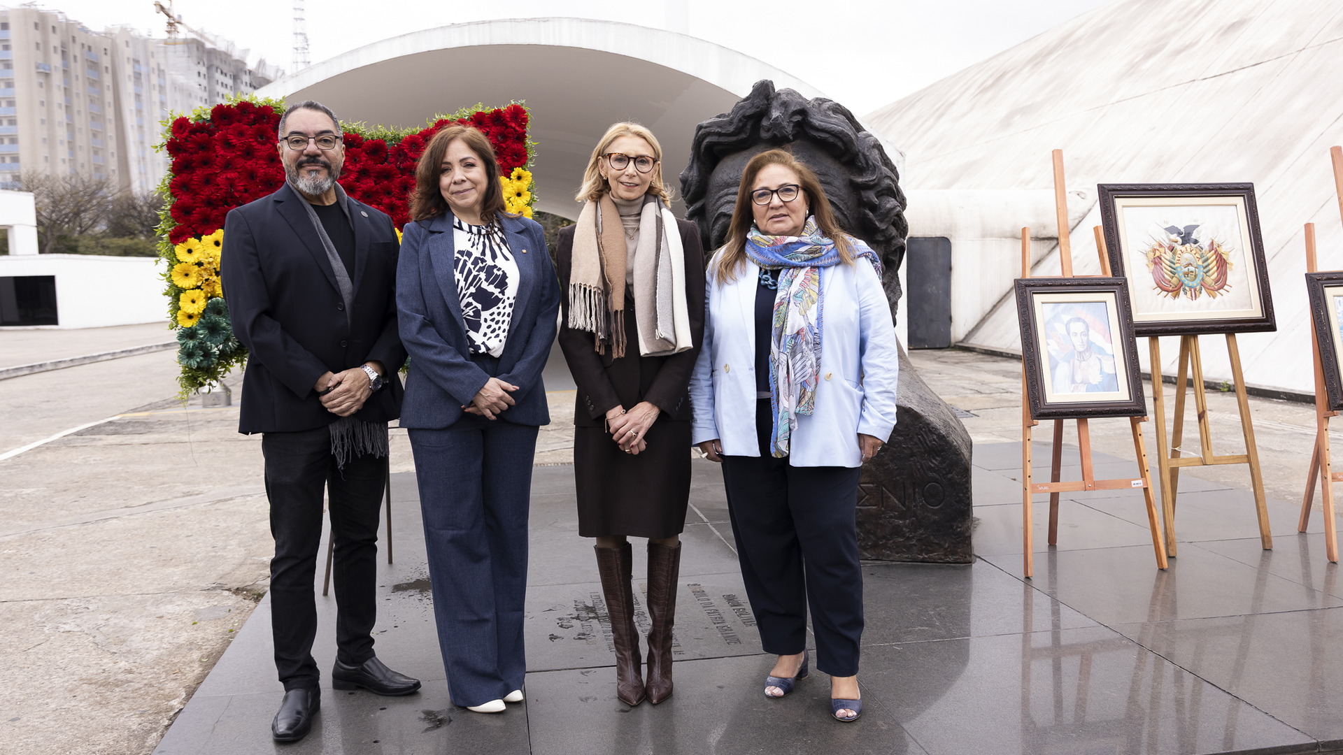 João Carlos Corrêa e invitados posan en un espacio expositivo con obras y elementos decorativos