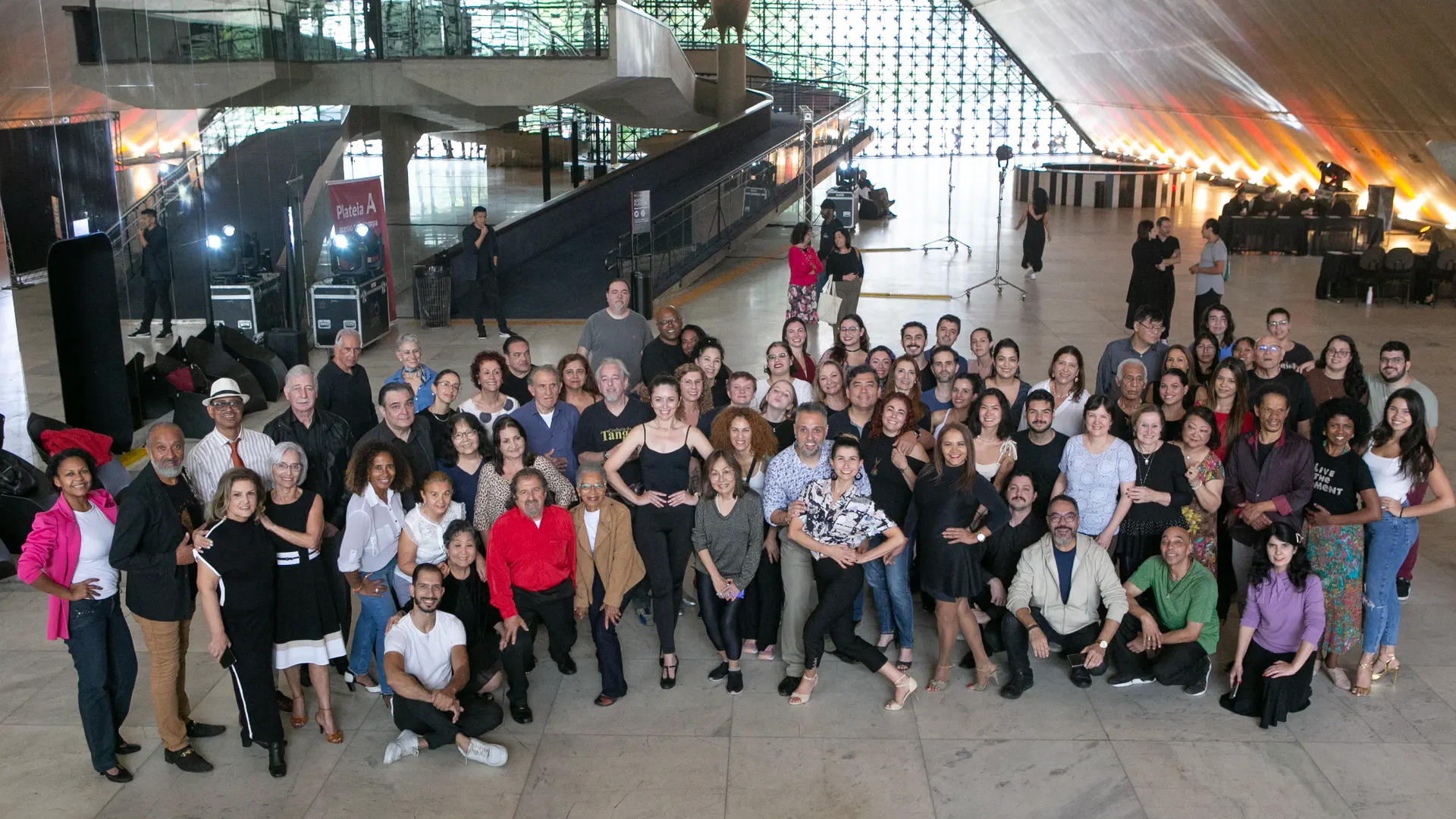 Gran grupo de participantes posa en un espacio interior después de una actividad de formación en tango