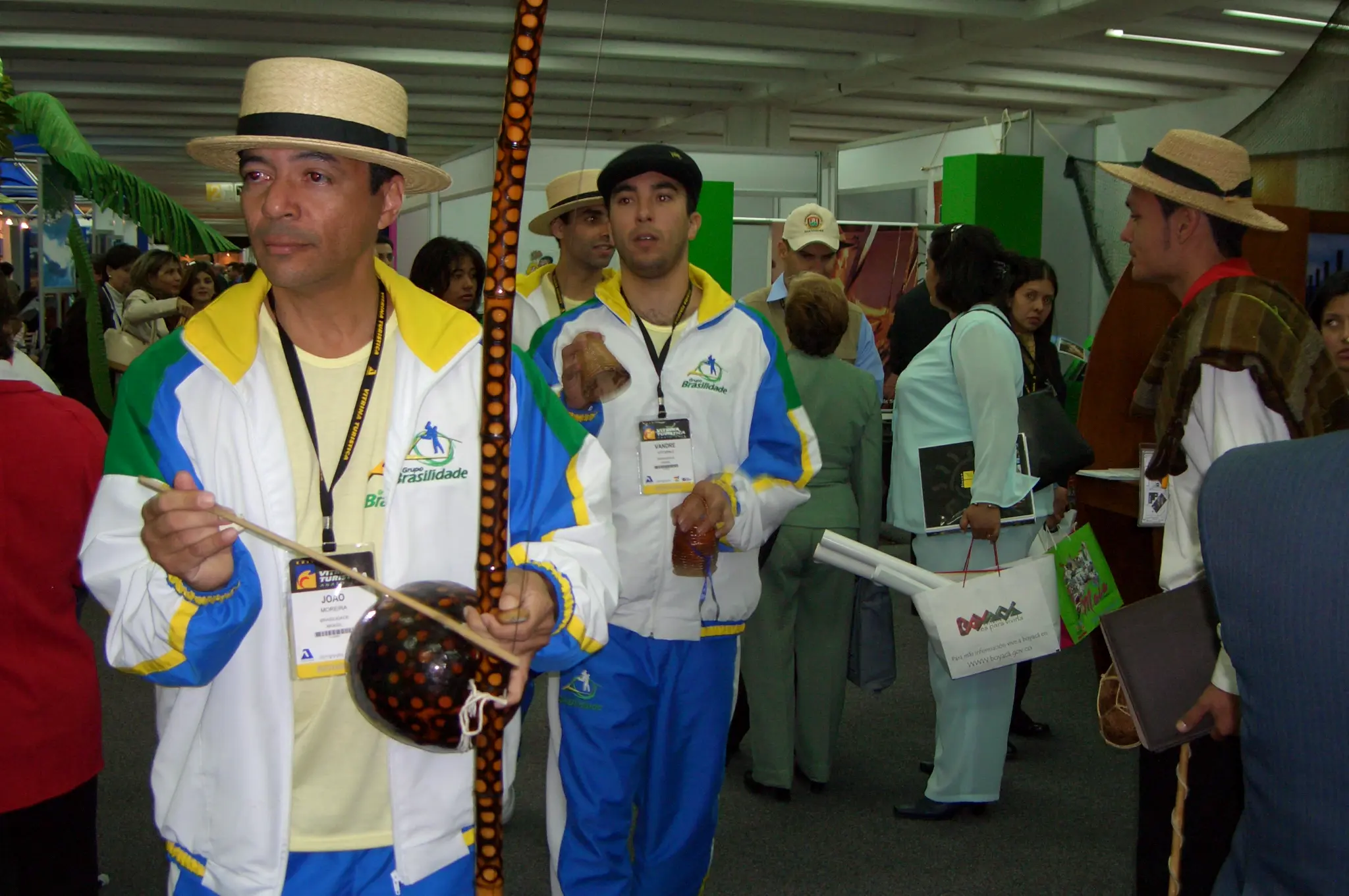 Integrantes do Grupo Brasilidade em evento, com figurinos do grupo, chapéus e instrumentos de música e dança