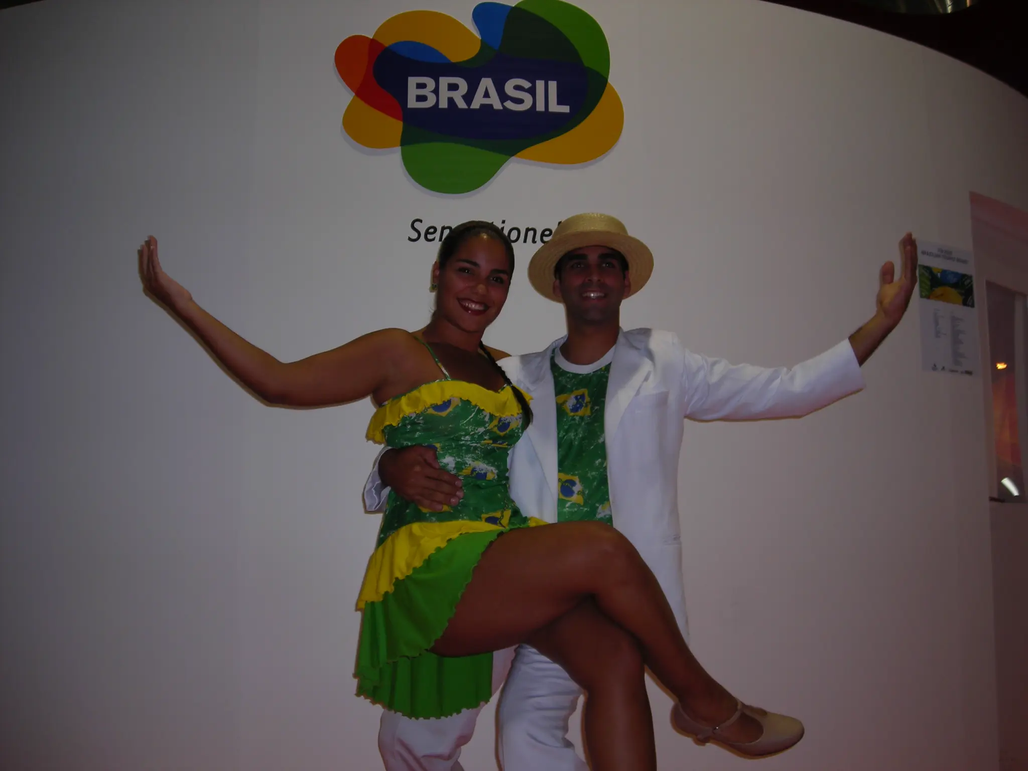 Casal de integrantes do Grupo Brasilidade posa com figurinos diante da identidade visual do Brasil em Berlim, em 2007
