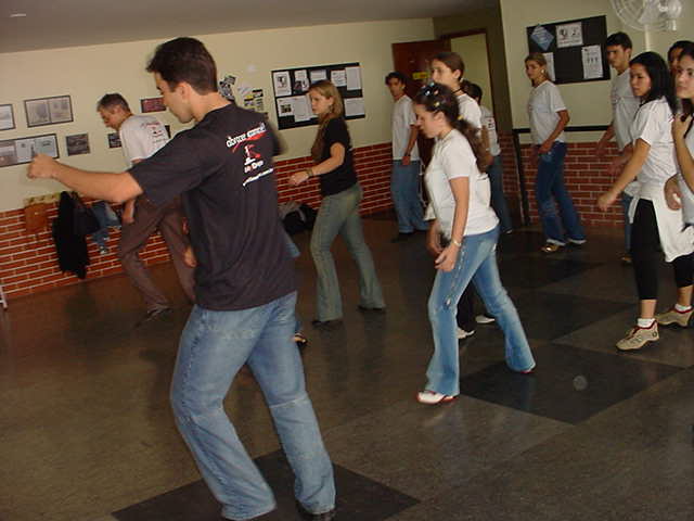 Integrante orienta atividade com o grupo disposto ao fundo