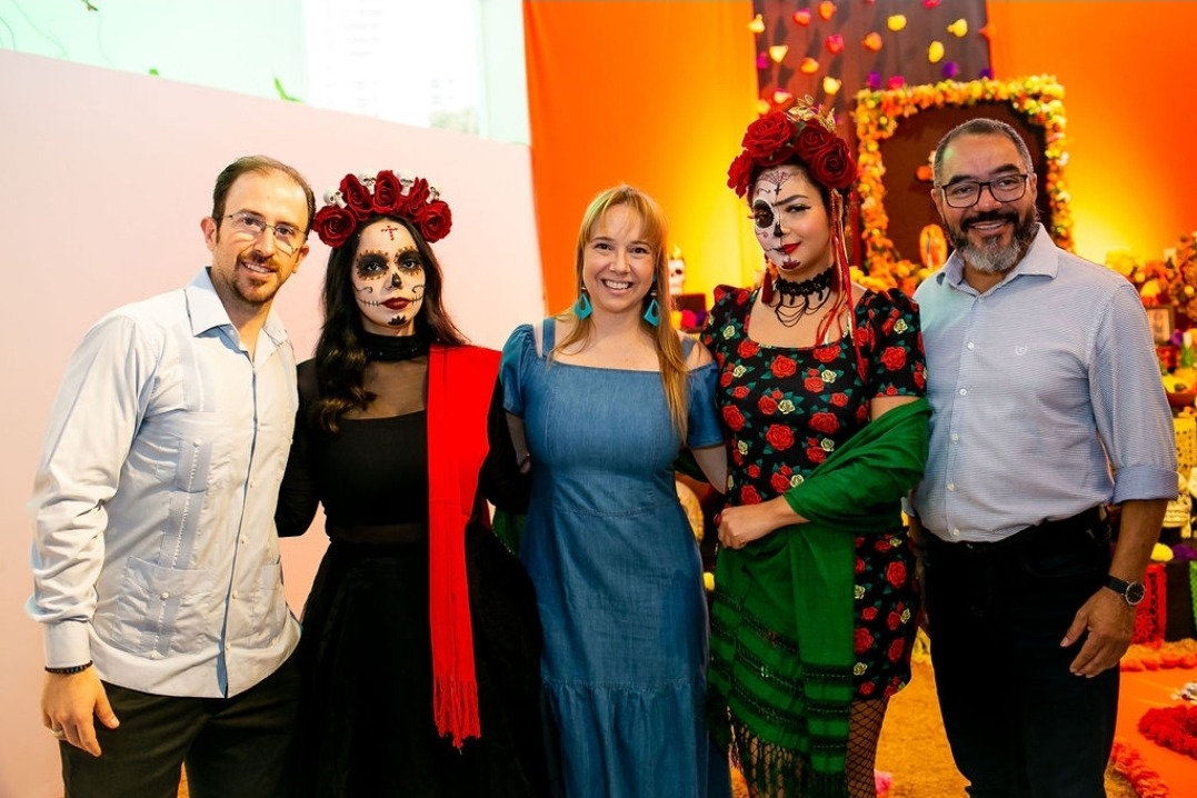 Rodrigo Vázquez, Marília Marton e João Carlos Corrêa posam com duas Catrinas em ambiente decorado para o Día de Muertos