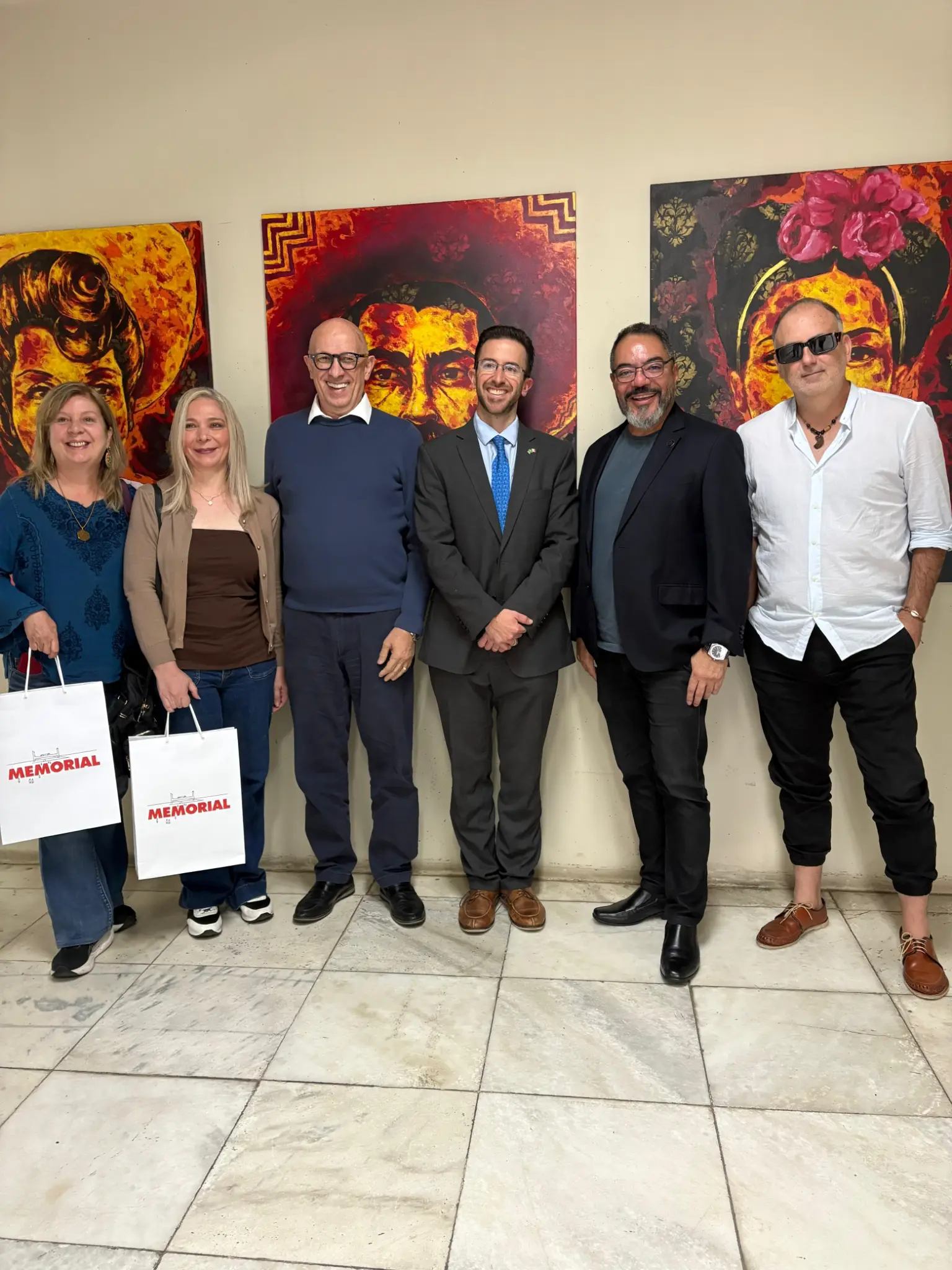 Rodrigo Vázquez, artistas mexicanos, João Carlos Corrêa e Roberto Bertani posam diante de pinturas coloridas durante apresentação de projetos de exposição
