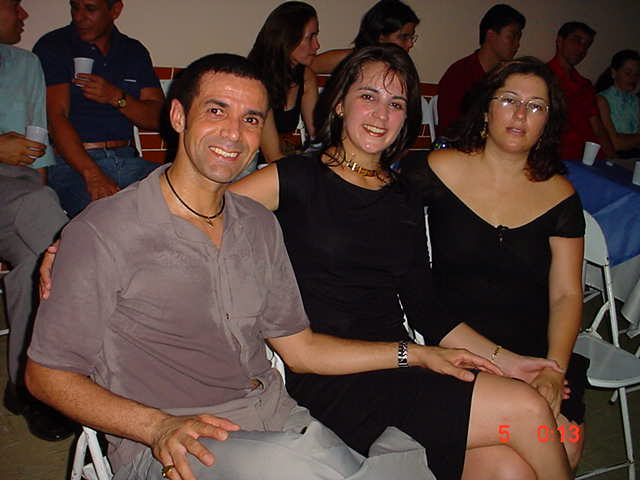 Três participantes reunidos à mesa durante momento de convivência